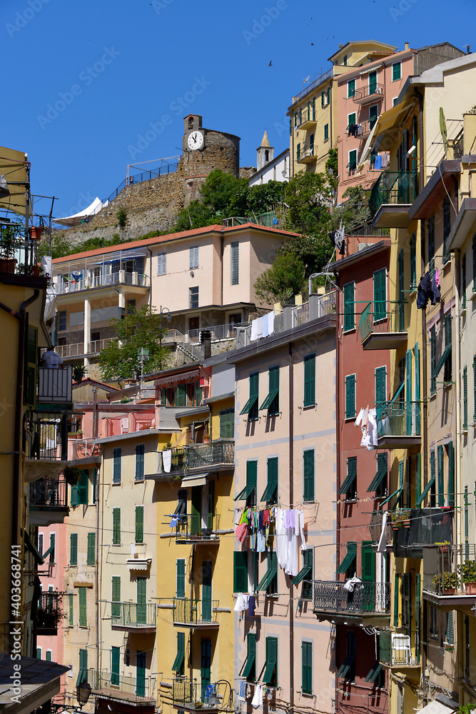 Typical street with its colorful facades of Village of Riomaggiore, a commune in the province of La Spezia, situated in a small valley in the Liguria region of Italy
