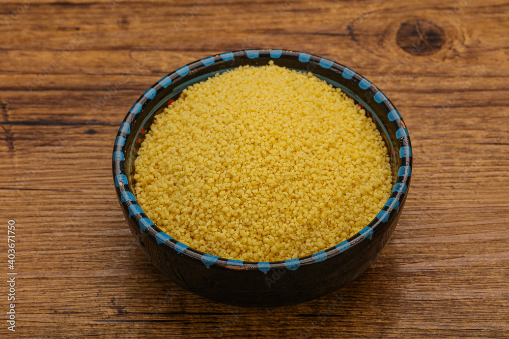 Raw cous cous heap in the bowl Raw cous cous heap in the bowl