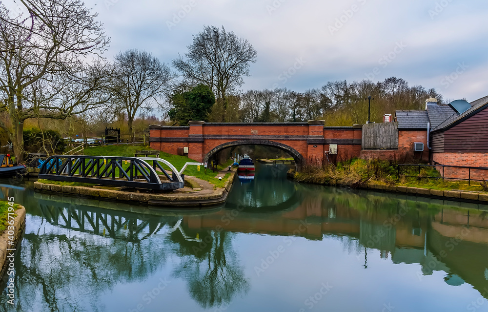 Looking towards the base of the inclined plane with the swing bridge in the foreground at the lower canal basin at Foxton Locks, UK on a still winter's afternoon Looking towards the base of the inclined plane with the swing bridge in the foreground at the lower canal basin at Foxton Locks, UK on a still winter's afternoon