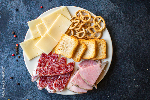 meat platter, ham slices, cheese plate and crackers sausage smoked or dry-cured salami tasty ready to cook and eat on the table meal snack outdoor top view copy space for text food background rustic