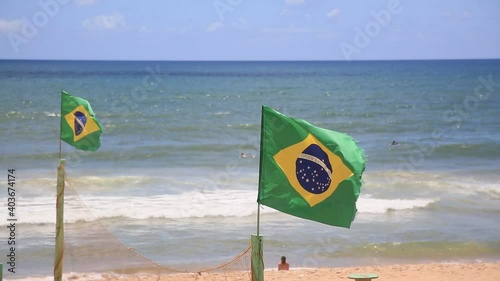 salvador, bahia, brazil - january 6, 2021: Brrazil\'s flag is seen on a mast on Armacao beach in the city of Salvador photo