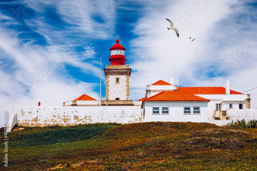 The lighthouse in Cabo da Roca. Cliffs and rocks on the Atlantic ocean coast in Sintra in a beautiful summer day, Portugal. Cabo da Roca, Portugal. Lighthouse and cliffs over Atlantic Ocean.