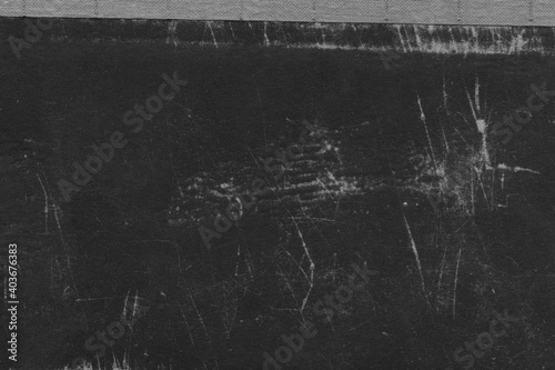 Cardboard black abstract texture close-up. Dark old paper background. Grunge concrete wall. Vintage blank wallpaper.