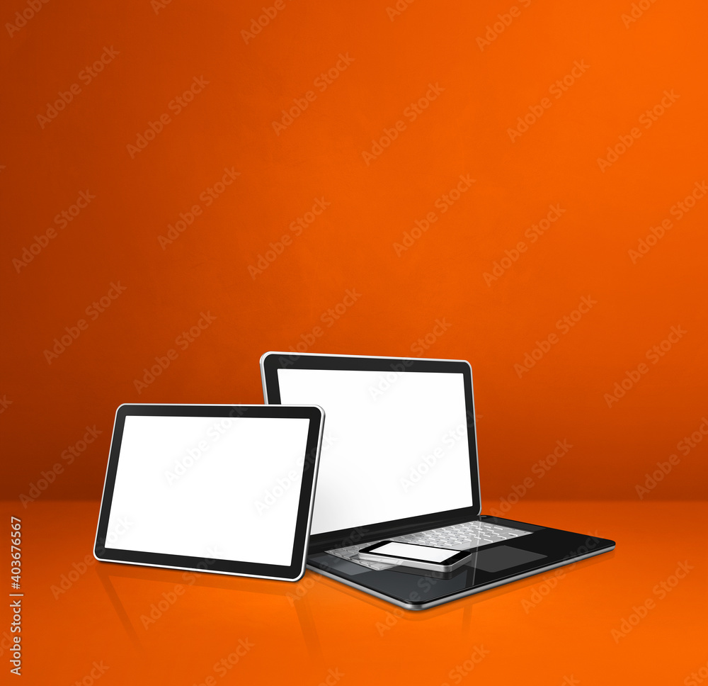 Laptop, mobile phone and digital tablet pc on orange office desk Laptop, mobile phone and digital tablet pc on orange office desk