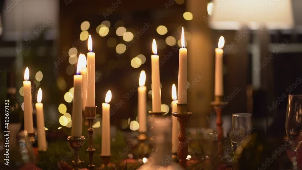 Low light. candles burning in the dark for a romantic date. dinner in a country house for Christmas or new year. Valentine's Day. The interior is retro styled. narrow depth of field. Low light. candles burning in the dark for a romantic date. dinner in a country house for Christmas or new year. Valentine's Day. The interior is retro styled. narrow depth of field.