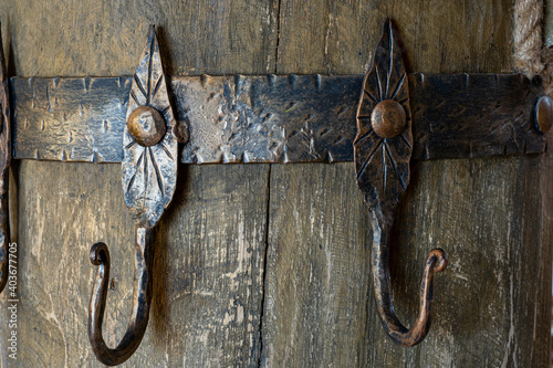 Ancient clothes hanger. Metal hanger in the Scythian style. Ancient castle photo