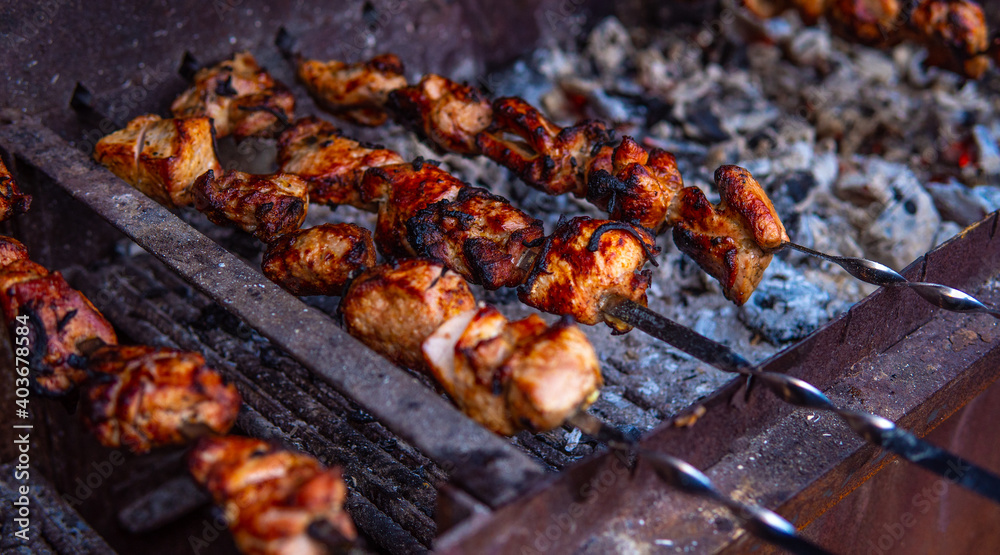 Fresh shish kebab on skewers is fried on the grill. Grilled meat on skewers. Fresh shish kebab on skewers is fried on the grill. Grilled meat on skewers.