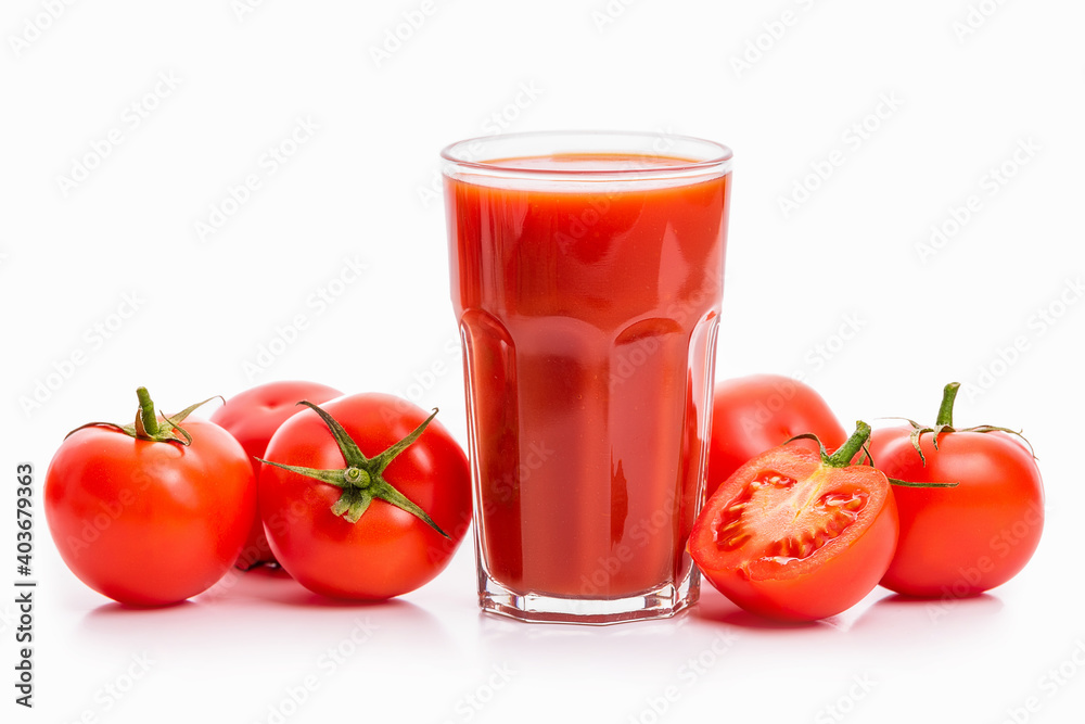 Tomato juice in a glass and tomatoes with green sepals Tomato juice in a glass and tomatoes with green sepals
