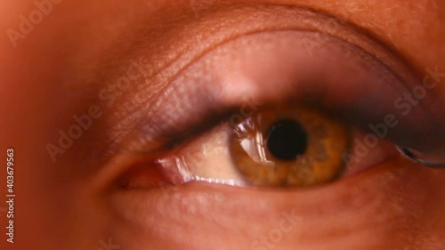 Macro. The female eye looks into the frame