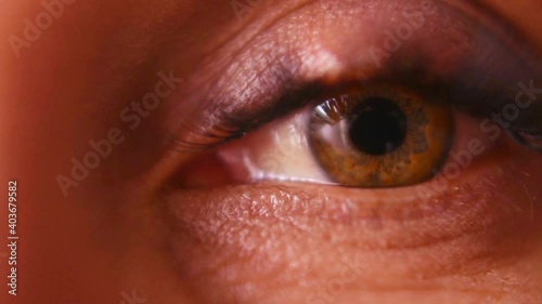 Macro. The female eye looks into the frame