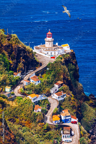 Dramatic view down to lighthouse on Ponta do Arnel, Nordeste, Sao Miguel Island, Azores, Portugal. Lighthouse Arnel near Nordeste on Sao Miguel Island, Azores, Portugal.
