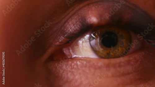Macro. The female eye looks into the frame