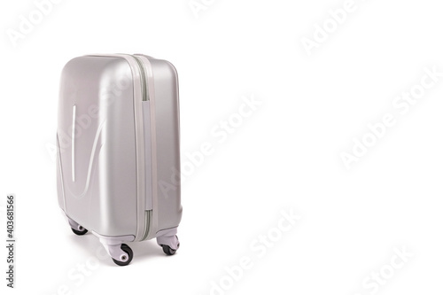 Suitcase isolated on white. Silver travel baggage bag or plastic luggage on white background. Summer vacation and product advertisement concept.