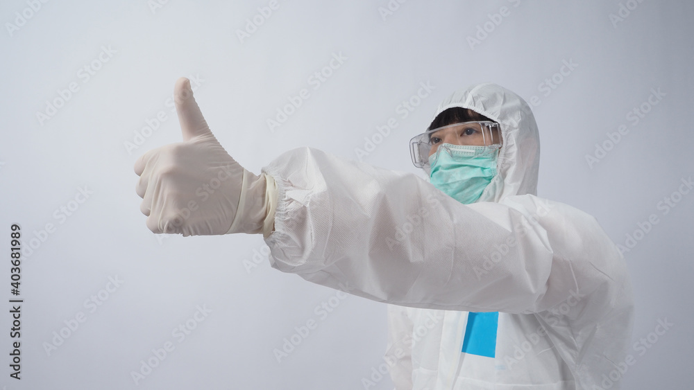 Doctor Gesture. Asian woman doctor in PPE suit or Personal Protection Equipment gesturing and point out. white medical rubber gloves. goggles glasses and green N95 mask to protect pandemic coronavirus Doctor Gesture. Asian woman doctor in PPE suit or Personal Protection Equipment gesturing and point out. white medical rubber gloves. goggles glasses and green N95 mask to protect pandemic coronavirus