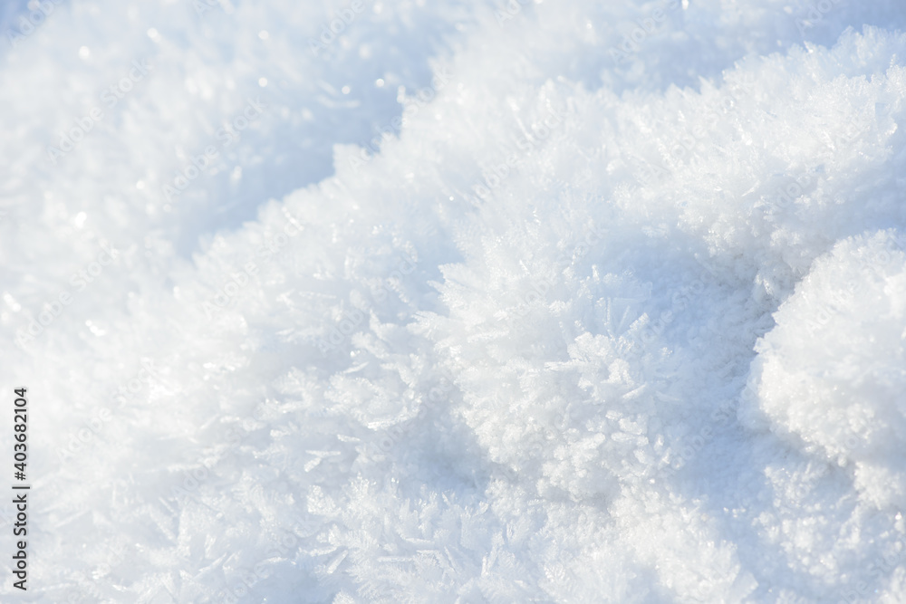 Hoarfrost background texture. Fresh ice and snow winter backdrop with snowflakes and mounds. Seasonal wallpaper. Frozen water geometrical shapes and figures. Cold weather atmospheric precipitation.