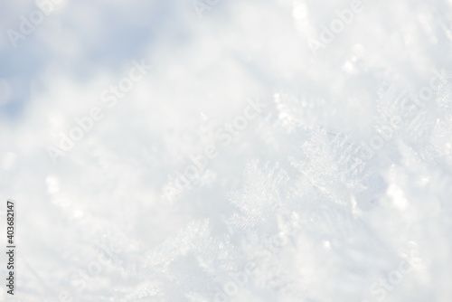 Hoarfrost background texture. Fresh ice and snow winter backdrop with snowflakes and mounds. Seasonal wallpaper. Frozen water geometrical shapes and figures. Cold weather atmospheric precipitation.