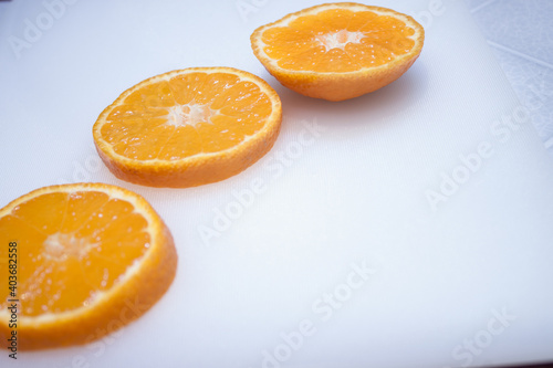 Isolated flying oranges. Falling sliced orange fruit isolated on white background with clipping path