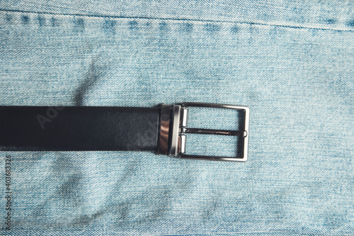 belt on jeans on wooden background