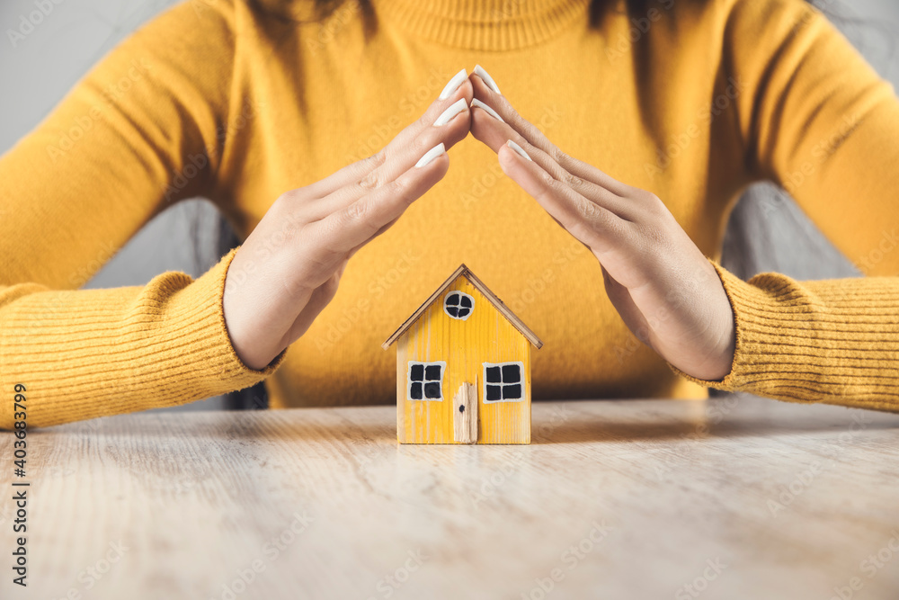 © ARAMYAN - woman holding yellow house model © ARAMYAN - woman holding yellow house model