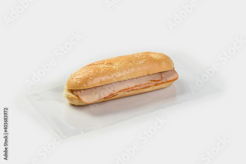 baguette with ham on a light background