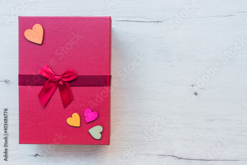 Red gift box on wooden table