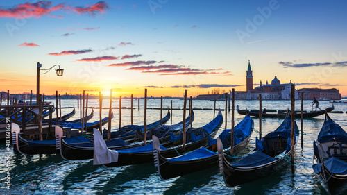Scenic view of San Giorgio Maggiore, gondolas and lamp at colorful sunrise, Venice, Italy. Sunset in Venice. Gondolas at Saint Mark's Square and church of San Giorgio Maggiore © daliu