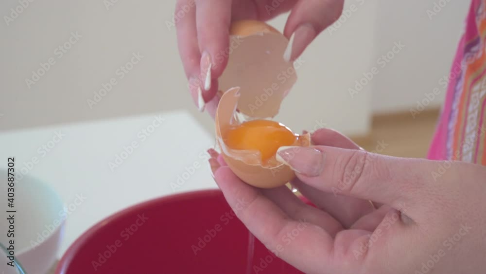 Breaking eggs into a bowl