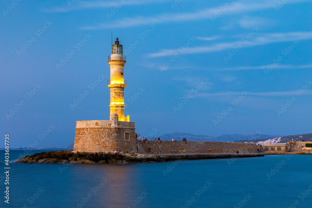 Venetian harbour and lighthouse in old harbour of Chania at sunset, Crete, Greece. Old venetian lighthouse in Chania, Greece. Lighthouse of the old Venetian port in Chania, Greece.