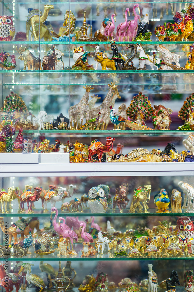 Glass window display shelf with dozens of colorful ceramic and glass souvenirs in Kusadasi, Turkey