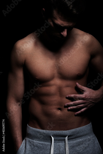 Fitness, man with athletic, muscular body, dark, on black background