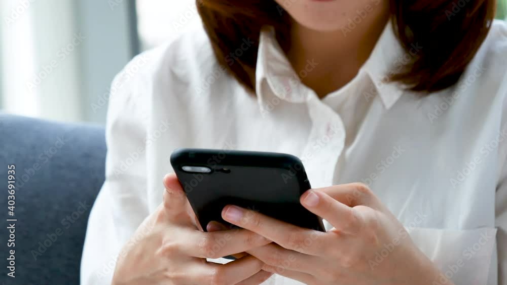 Young start up business woman working enjoy good news from smartphone. Asian Business people working at home office with happiness Young start up business woman working enjoy good news from smartphone. Asian Business people working at home office with happiness