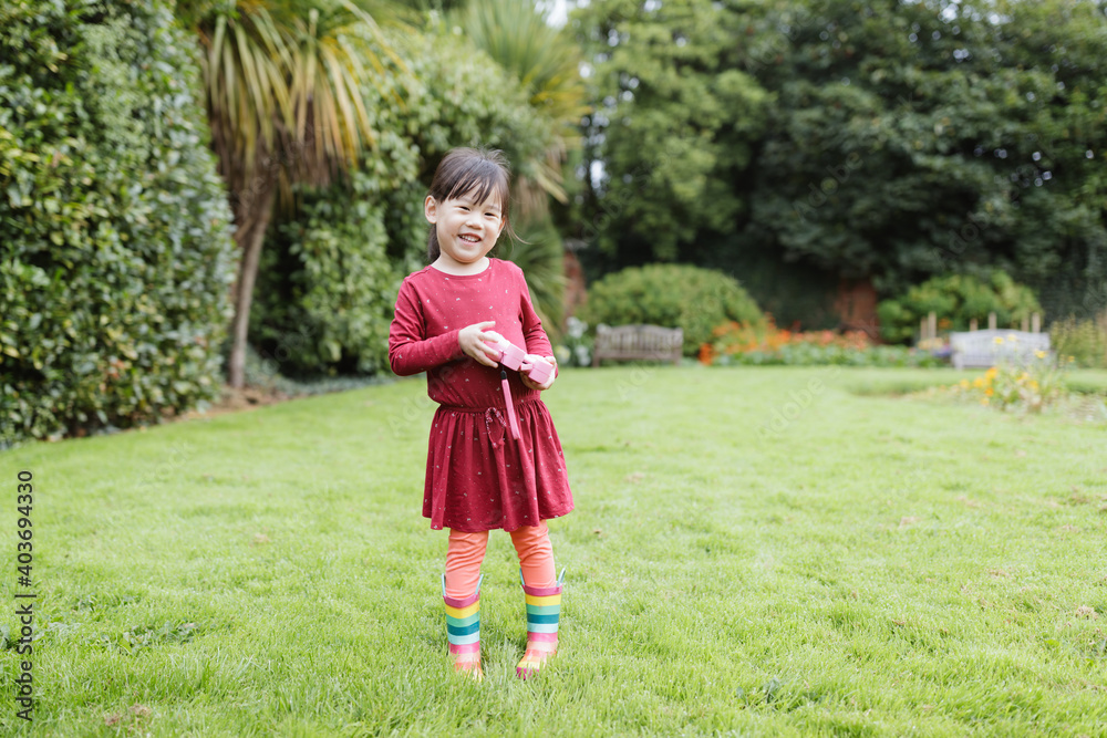 young girl taking photo in the summer garden morning young girl taking photo in the summer garden morning