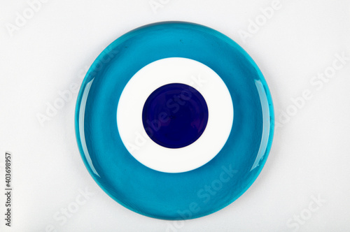 Glass Turkish eye on white background Evil eye amulet protect from bad things using by turkish culture. photo