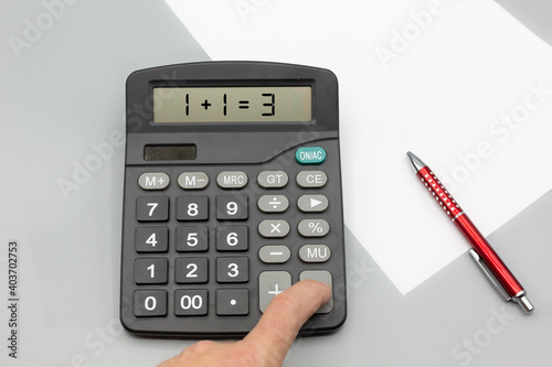 Calculator on office desk with incorrect calculation, paper and pen © peter brauers