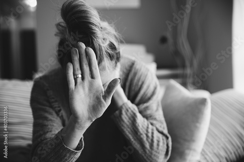 Obraz na płótnie Lonely, unhappy woman with her hand outstretched sitting alone on the floor feels disappointed and depressed. Sadness and depression. w salonie