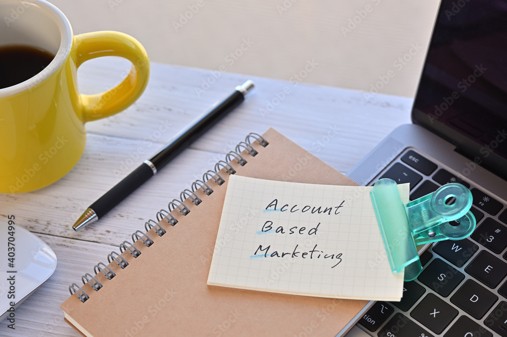 There's a note pinned to a clip on my desk. It says something like Account Based Marketing on it. There's a coffee and a pen and a laptop nearby. There's a note pinned to a clip on my desk. It says something like Account Based Marketing on it. There's a coffee and a pen and a laptop nearby.