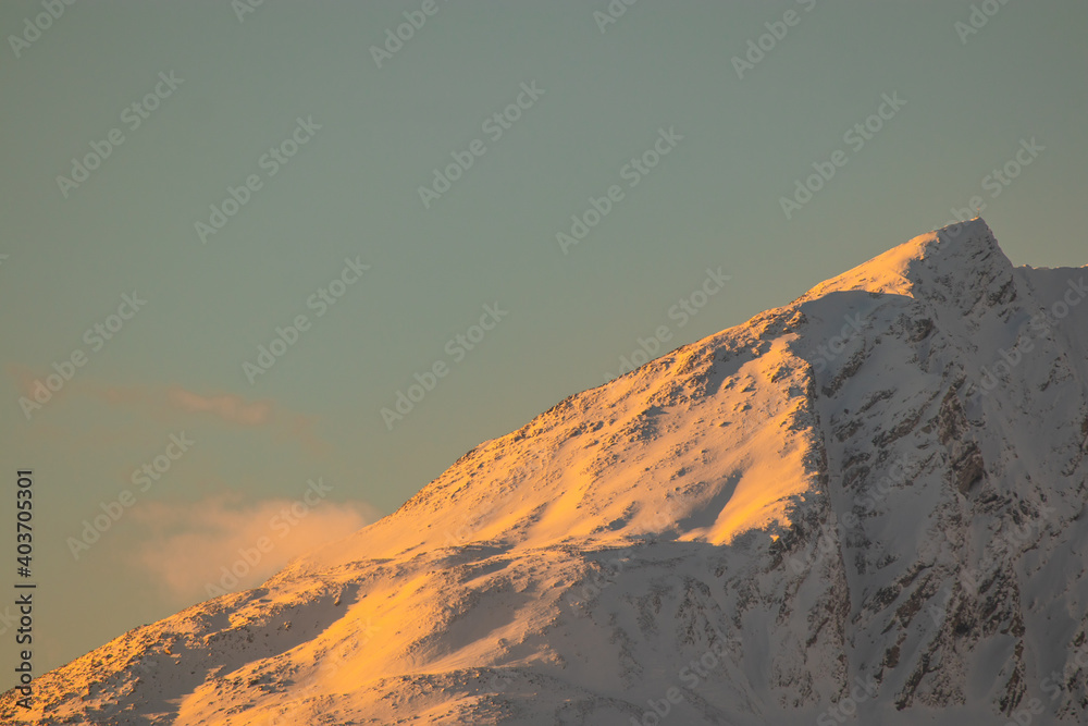 Winter panorama of mountains in swiss alps above the valley of Brig, viewed from the Simplon pass in early evening at sunset