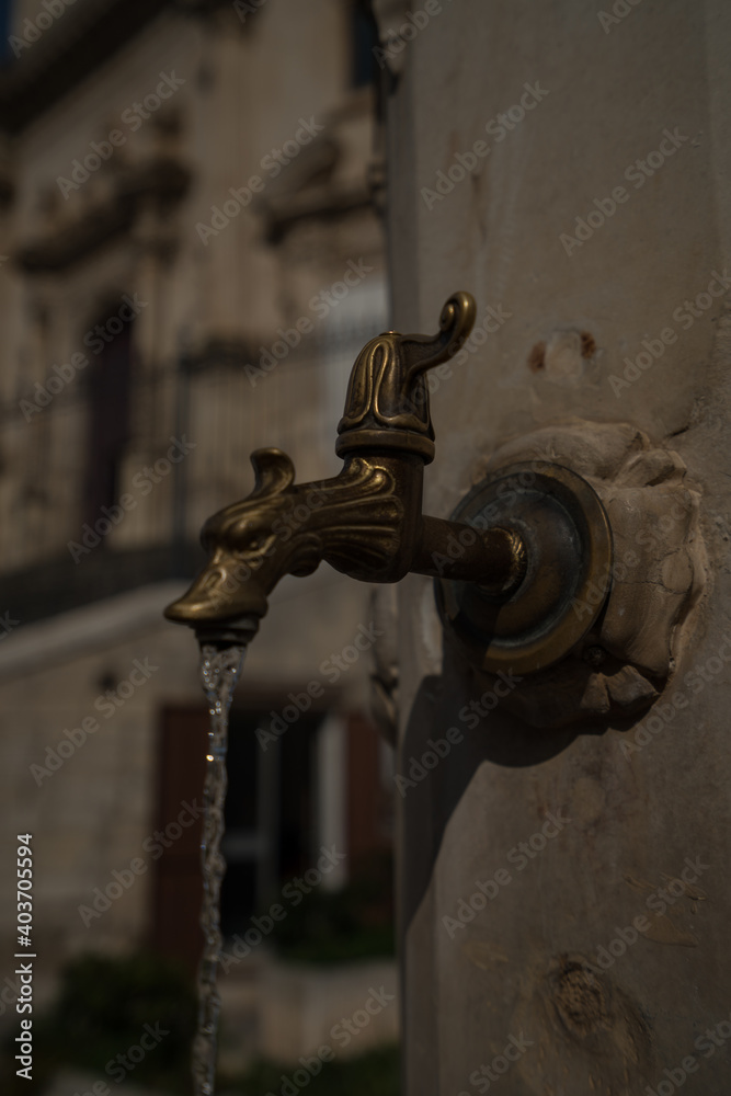 Old open water tap Ragusa Sicily Italy