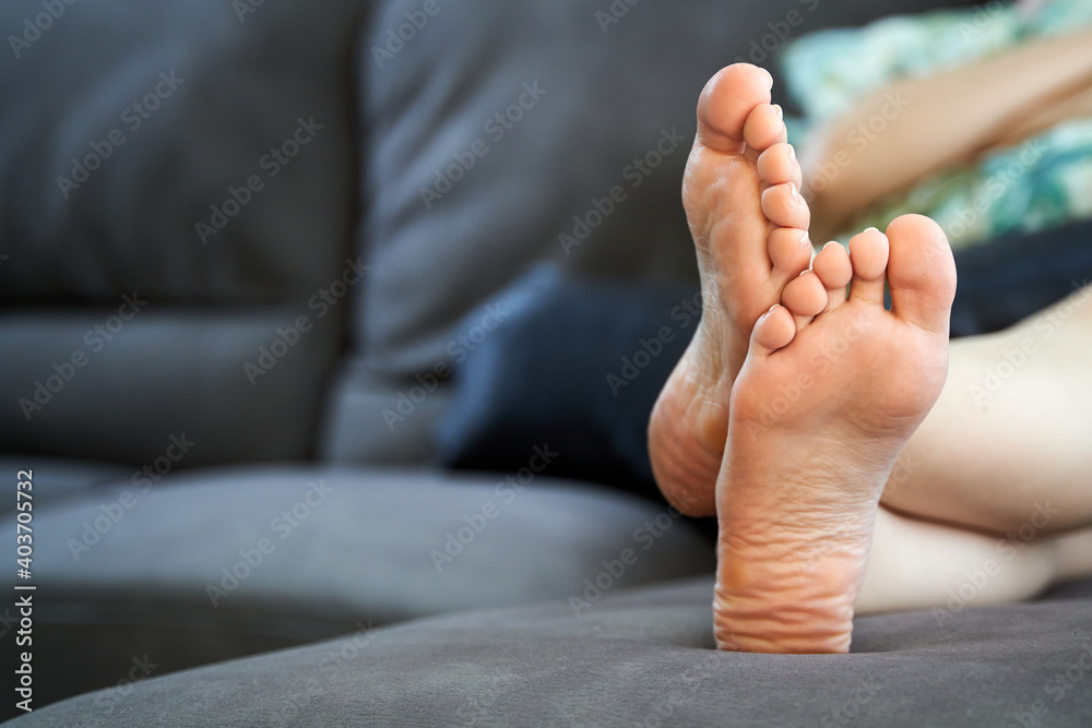 barefoot woman feet resting on a couch Stock Photo Adobe Stock