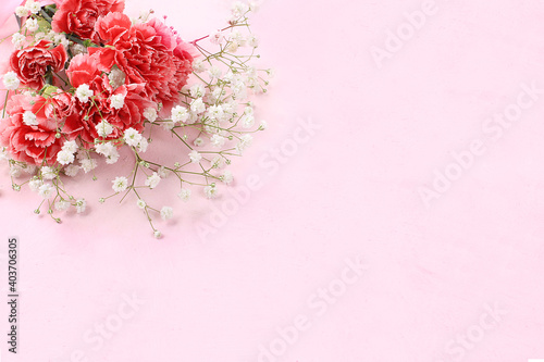 Abstract floral composition, spring background. Carnations on pink background, minimal holiday concept. Postcard for womens day or mothers day, happy birthday, wedding, banner