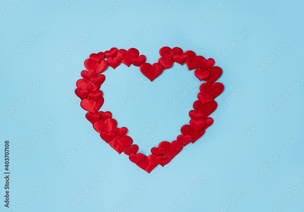 Red decorative hearts laid out in the shape of one big heart. Love concept. Wedding frame. Place for text.