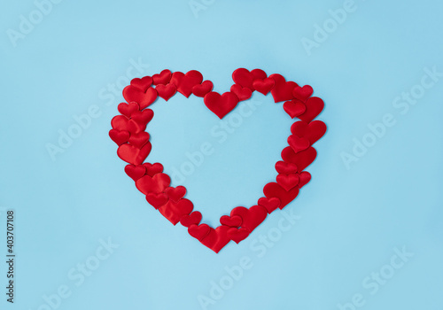 Red decorative hearts laid out in the shape of one big heart. Love concept. Wedding frame. Place for text.
