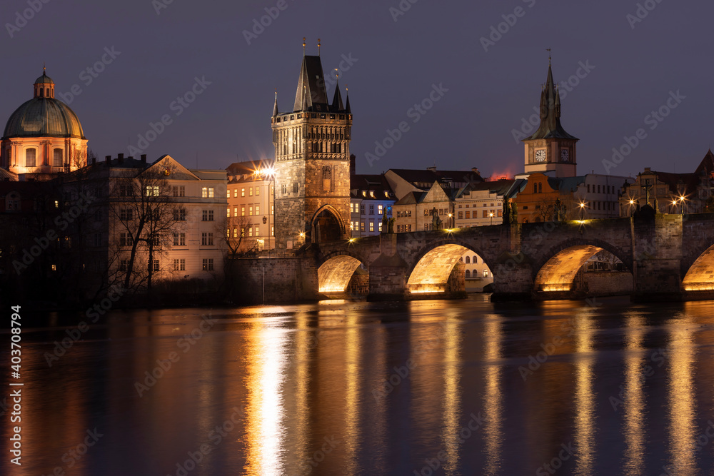 .Charles Bridge at night and light from street lights on the Vltava River in the center of Prague at night in the Czech Republic