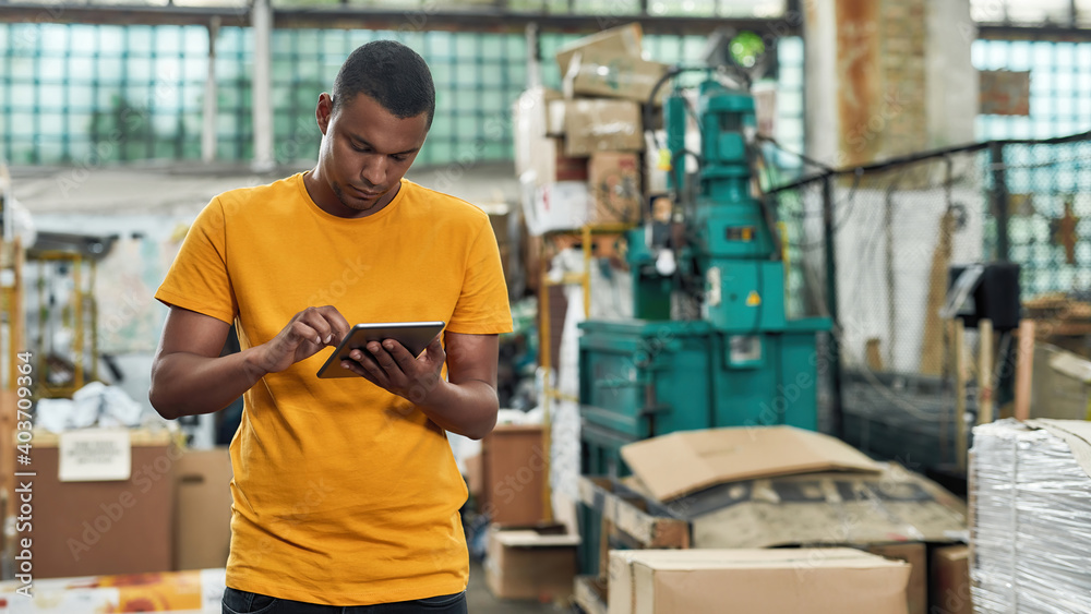 Young man working with digital tablet on garbage station