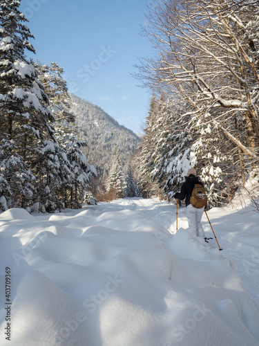 Woman Snowshoeing on Snowy Path