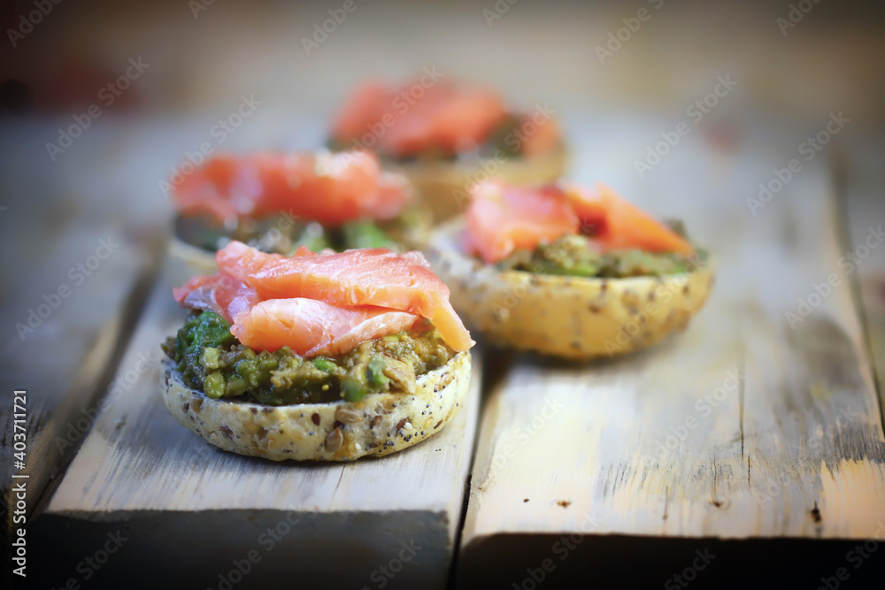 Selective focus. Fish burgers with salmon and avocado. Healthy snack. Healthy fast food. Selective focus. Fish burgers with salmon and avocado. Healthy snack. Healthy fast food.