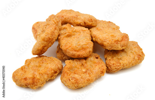 a pile of chicken nuggets on a white background