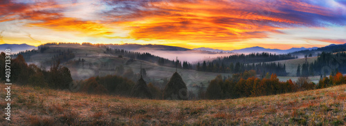 Majestic autumn rural scenery. Landscape with mountains with morning fog