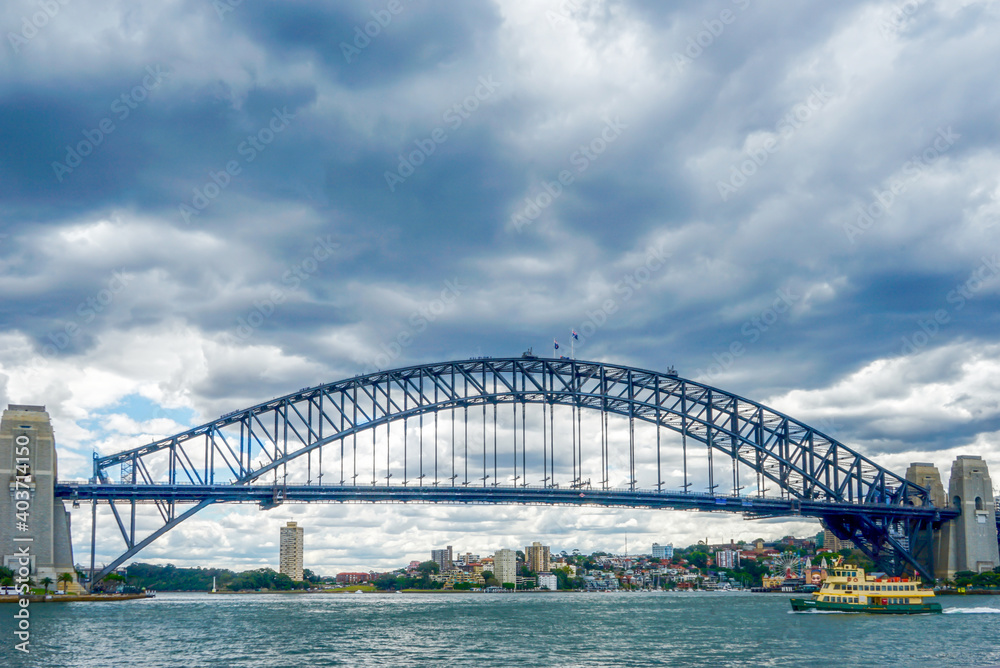 Fototapeta premium Australia, Sydney, Harbour Bridge seen from a boat in the Sydney Bay.