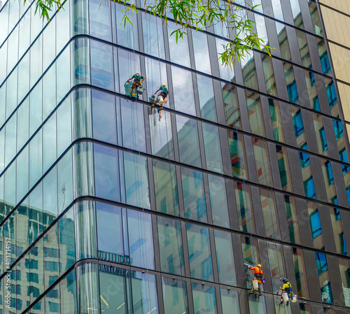 Australia, window cleaners on a high rise building.